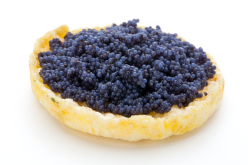 Canapes with black sturgeon caviar on the isolated white background.