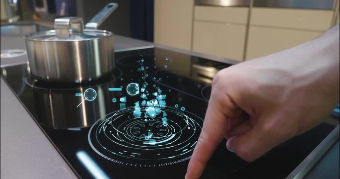 Close up of a man who cooks in his own home on a stove of the latest technology and regulates power and intensity thanks to holography. Concept of: future, technology, kitchen, augmented reality.