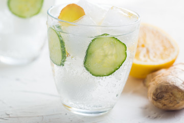 Sassy detox water with lemons, cucumbers and ginger. Healthy breakfast.
