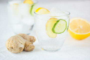 Sassy detox water with lemons, cucumbers and ginger. Healthy breakfast.