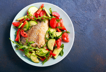 Vegetable salad and fried dorado fish