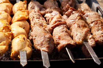 Meat pieces on sticks grilling