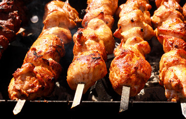 Meat pieces on sticks grilling