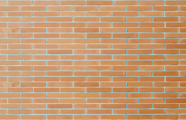 Red brick wall textured background with light source from top left corner