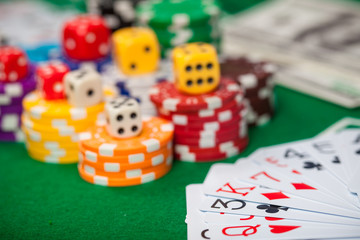 Poker chips on table in casino. Cards on green felt casino table