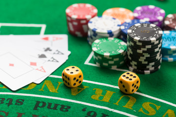 Dice on casino game table. Poker chips on table in casino