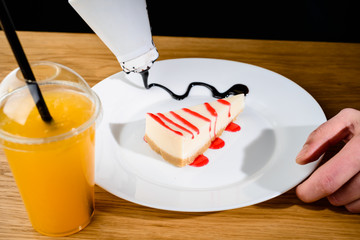 Process of preparing delicious sweet piece of curd pie and orange juice on the table