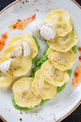 Close-up of ravioli on a bedding of green peas puree, view from above