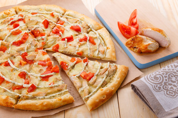 Still life of pizza with chicken and tomatoes