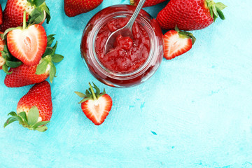 strawberry jam with fresh strawberries. marmalade on spoon and jar