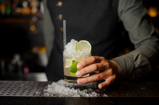 Bartender serving a cocktail at bar counter