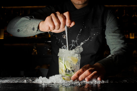 Bartender making cocktail at the bar counter