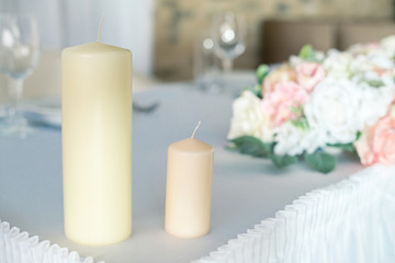 Two candles on the decorated table for celebration holidays