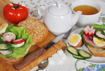 boiled hard-boiled egg with cucumber sandwiches, cucumber and radish and tea