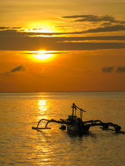 Background of sunset and a fisherman boat at Bali, Indonesia 