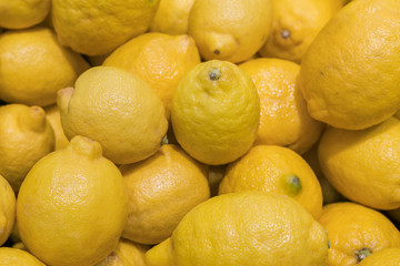 Colorful Display Of Lemons In Market. background