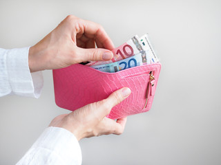 Euro in pink wallet.