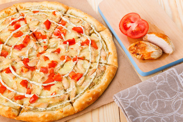 Still life of pizza with chicken and tomatoes