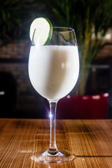 Milkshake with lime in a glass.