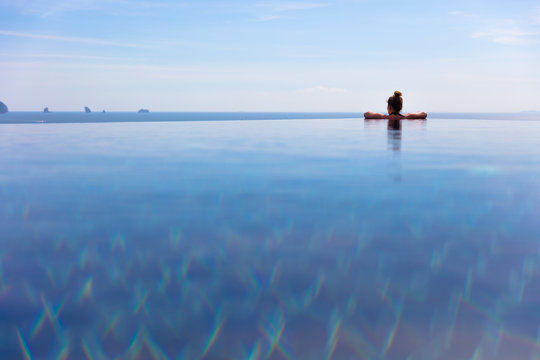 Woman Resting In Infinity Pool At a Aonang Beach Resort