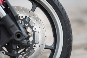 Color shot of a motorcycle forks and tire.