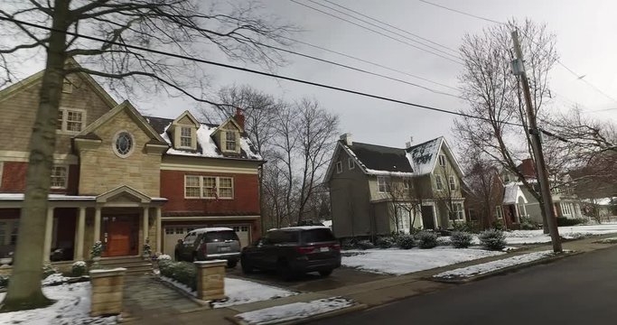 A driver's side perspective on the streets of an upscale residential neighborhood on a late winter day. Pittsburgh suburbs.  	