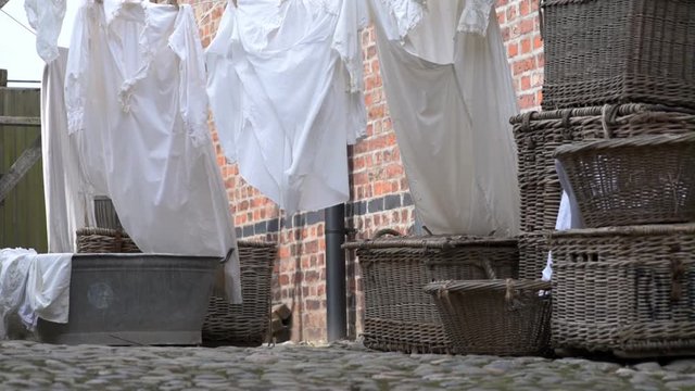 Old fashioned washing baskets and laundry drying on a line.