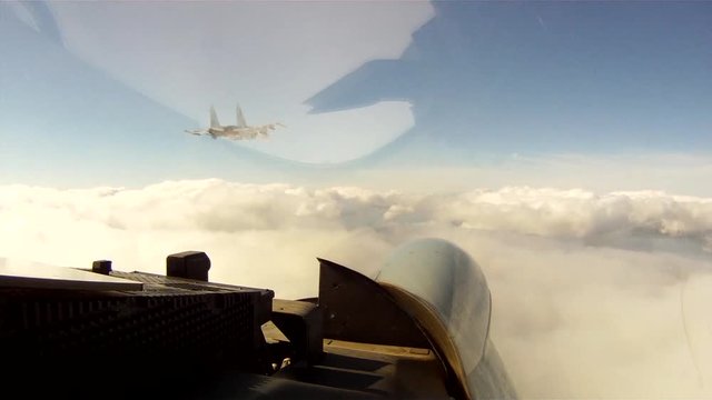Russian army fighter Su-30 ( Flanker-C) flying in the clouds