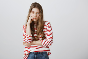 Girl almost sleeps from boredom during class. Portrait of indifferent tired female model supporting...