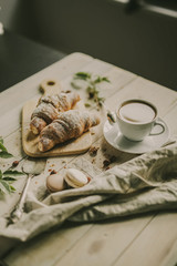 French tasty breakfast with coffee and sweet croussant and macarons
