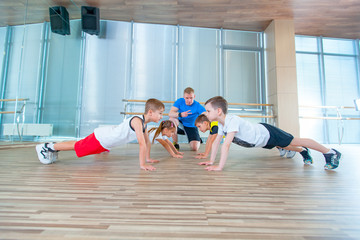 Children at physical education lesson in school gym gymnast kid