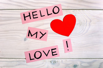 Message hello my love with heart shape on wooden table.