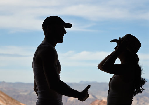 Silhouette of young couple looking at each other
