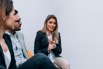 Three collegues talking in the office, during the break.