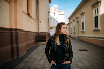 Fototapeta premium Young brunette woman walking european city streets.