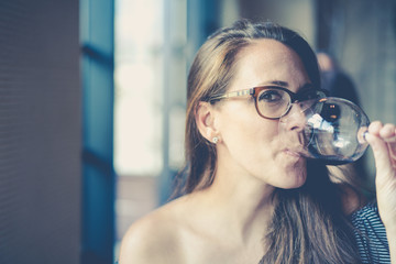 Woman drinking wine at a bar