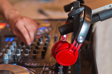 Dj mixer with headphones at nightclub . Dj mixes the track in the nightclub at party . DJ. sound equipment .