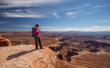 Fototapeta premium Hiker rests in Canyonlands National park in Utah, USA