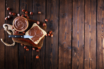 Homemade hazelnut spread with toast and in wooden bowl for breakfast. Hazelnut Nougat cream