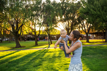 A mother with baby son in green neighborhood