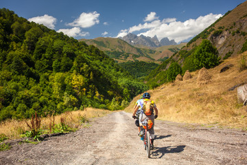 Obraz premium Mountain bikers are travelling in the highlands of Tusheti region, Georgia
