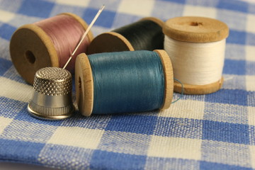 wooden spools with colored cotton threads for sewing, vintage