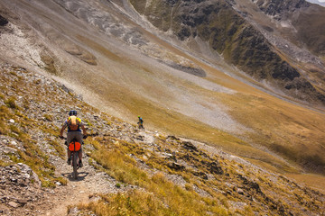 Fototapeta premium Mountain bikers are travelling in the highlands of Tusheti region, Georgia