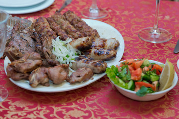 Meat kebab inside the stove. Steak kebab. Salad . Chopped onion . Chopping kebab . Shashlyk . Kiebab .