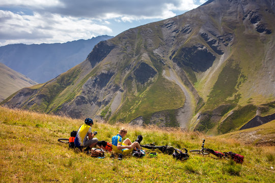 Cyclists rest in the mountains while biking