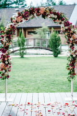Arch for wedding ceremony a is decorated with pink hydrangeas, roses, white carnations flowers and...