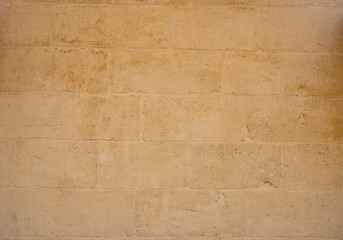 Traditional weathered stone wall background in Malta