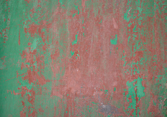 Weathered green red painted wall background partly faded