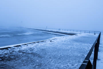 winter image of a harbor in fog