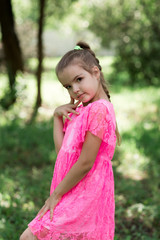 Fashion portrait of stylish girl smiling and posing at camera. Walking in park at summertime.